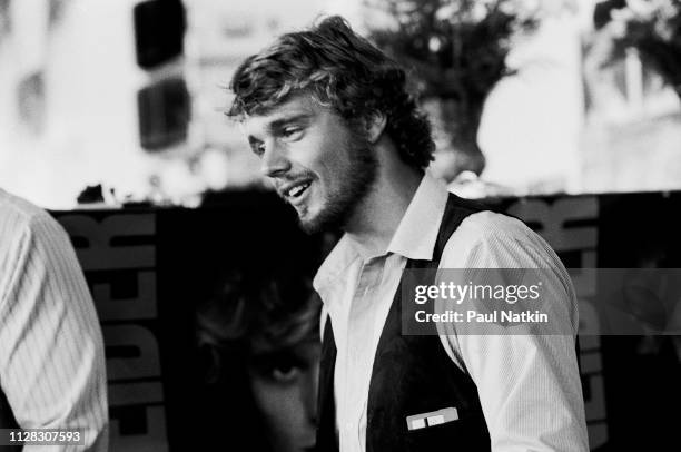 American Country musician and actor John Schneider smiles as he signs autographs during an event to promote his self-titled debut album at an...