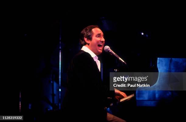 American Pop musician Neil Sedaka plays piano as he performs onstage at the Park West, Chicago, Illinois, November 25, 1978.