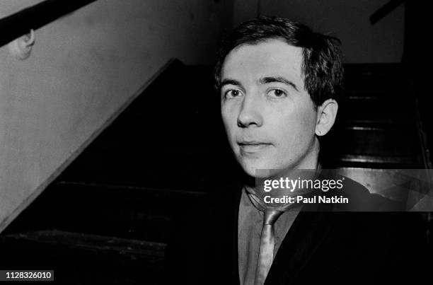 Portrait of English musician Pete Shelley as he poses on a staircase, backstage at Stages nightclub, Chicago, Illinois, April 25, 1982.