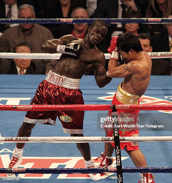 Action from the third round as Manny Pacquiao takes a left from Joshua Clottey in the main event, the 12-round WBO World Welterweight title bout, at...
