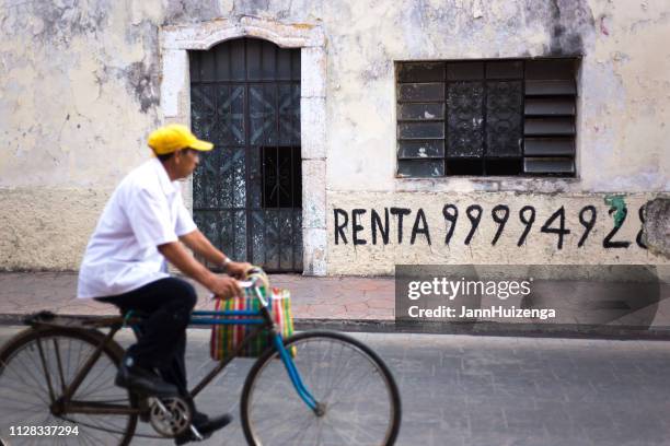 valladolid, yucatan, mexico: downtown cyclist - for rent sign stock pictures, royalty-free photos & images