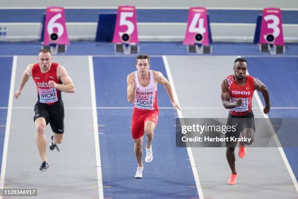 Silvian Wicki of Switzerland, Markus Fuchs of Austria and Emre Zafer Barnes of Turkey compete in the qualification races of the men's 60m event on...