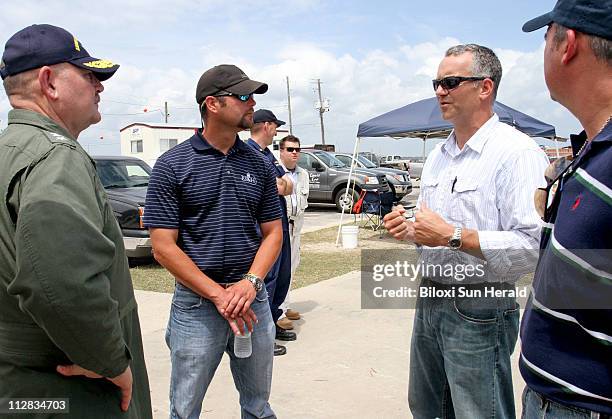 Coast Guard Admiral Thad Allen, national incident commander, left, talks to contractors Sean Short of ES&H, and Shawn Essert of Blue Group and Jerry...