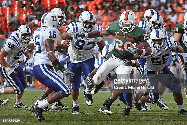 Miami's Damien Berry breaks through Duke's defense for a first down in third-quarter action at Landshark Stadium in Miami, Florida, Saturday,...