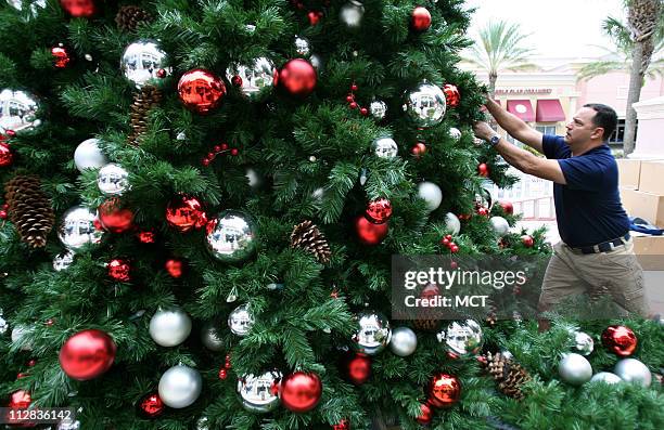 Ron Barnett and the team from Blown Away Orlando Property Services assemble and decorate the Christmas tree in the town square at the Winter Park...