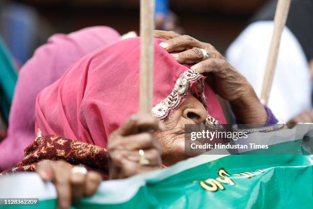 An old woman from tribal community participates in a protest march from Mandi house to Jantar Mantar for their demand of safe tribal and jungle land...