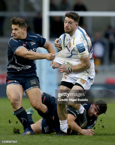 Rob Webber and Rohan Jan Van Rensburg of Sale Sharks tackle Alex Cuthbert of Exeter Chiefs during the Gallagher Premiership Rugby match between Sale...