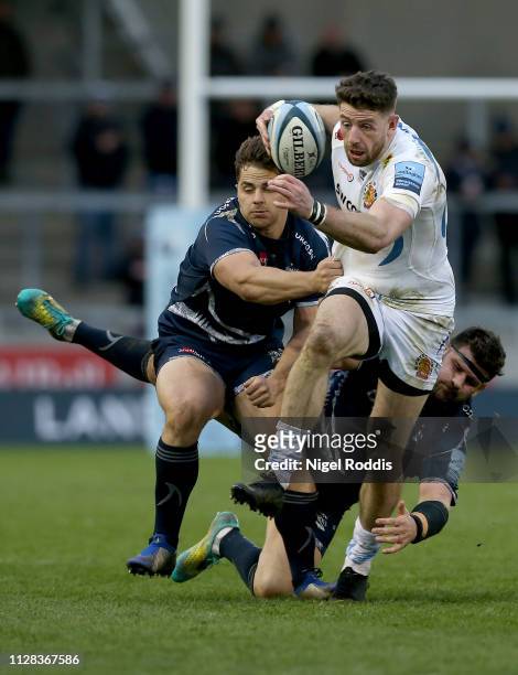 Rob Webber and Rohan Jan Van Rensburg of Sale Sharks tackle Alex Cuthbert of Exeter Chiefs during the Gallagher Premiership Rugby match between Sale...