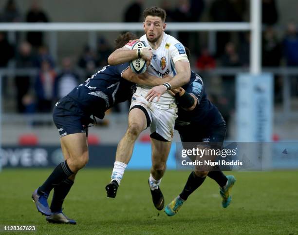Rob Webber and Rohan Jan Van Rensburg of Sale Sharks tackle Alex Cuthbert of Exeter Chiefs during the Gallagher Premiership Rugby match between Sale...