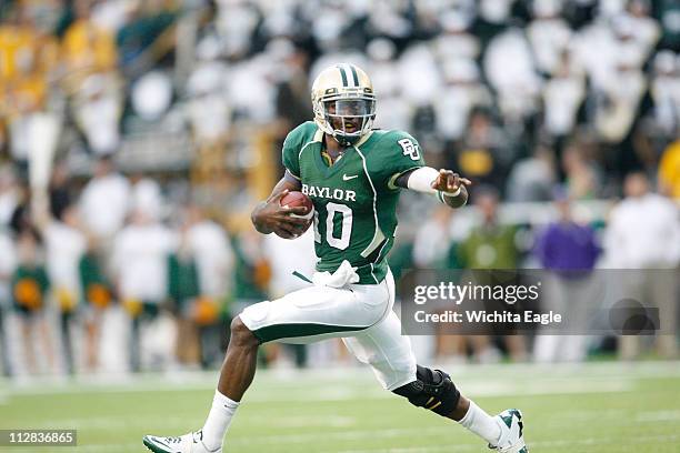 Baylor Bears quarterback Robert Griffin III slips away from Kansas State Wildcats cornerback David Garrett during an NCAA football game against...