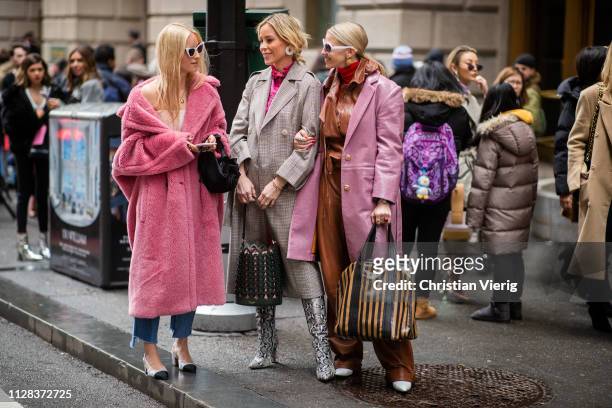 Charlotte Groeneveld is seen wearing pink teddy coat, Mary Lawless Lee and a guest wearing brown leather pants outside Kate Spade during New York...