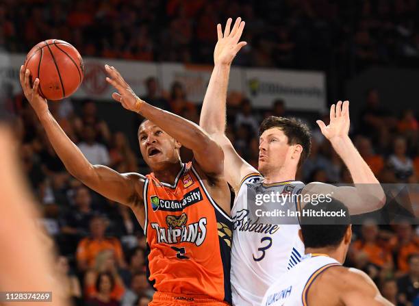 Devon Hall of the Taipans attempts a lay up past Cameron Gliddon of the Bullets during the round 17 NBL match between the Cairns Taipans and the...