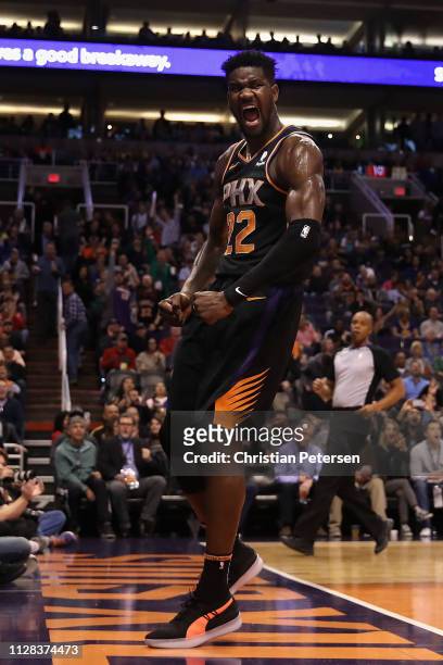 Deandre Ayton of the Phoenix Suns reacts after a slam dunk against the Golden State Warriors during the second half of the NBA game at Talking Stick...