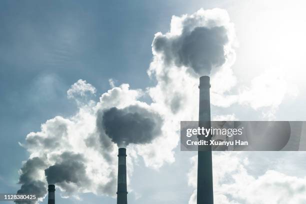 smoke stacks at a power plant. - växthusgas bildbanksfoton och bilder