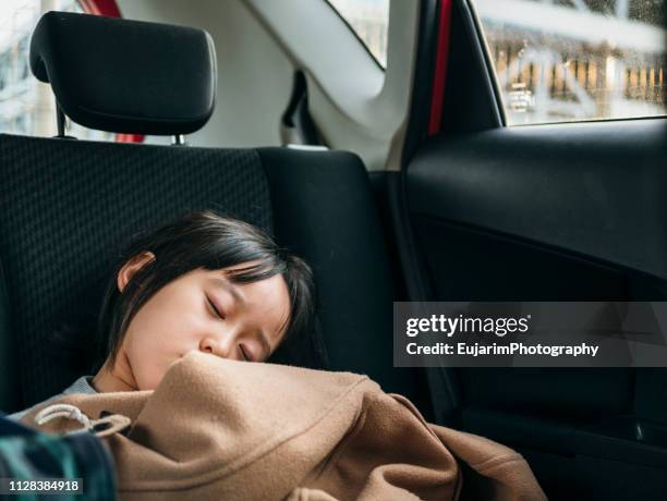 cute japanese girl sleeping in the car back seat - sleeping in car stock pictures, royalty-free photos & images