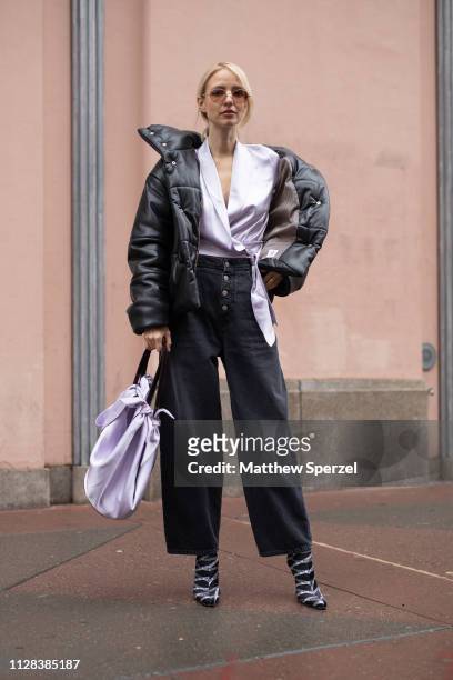 Leonie Hanne is seen on the street during New York Fashion Week AW19 wearing silver top with black down coat and silver bag on February 08, 2019 in...
