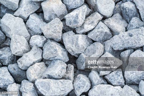 crushed gray rocks on the ground - minirock stock pictures, royalty-free photos & images