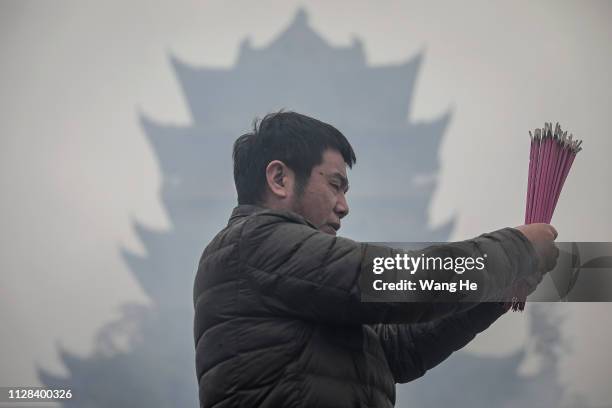 Man worships the God of Fortune at the Guiyuan Temple on February 09, 2019 in Wuhan, Hubei province, China. The fifth day in the lunar new year is...