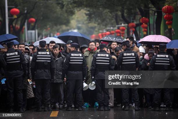 Police secure a crowd of Chinese worshippers as they line-up to pray for good fortune on the fifth day of the Lunar New Year at the Guiyuan Temple on...