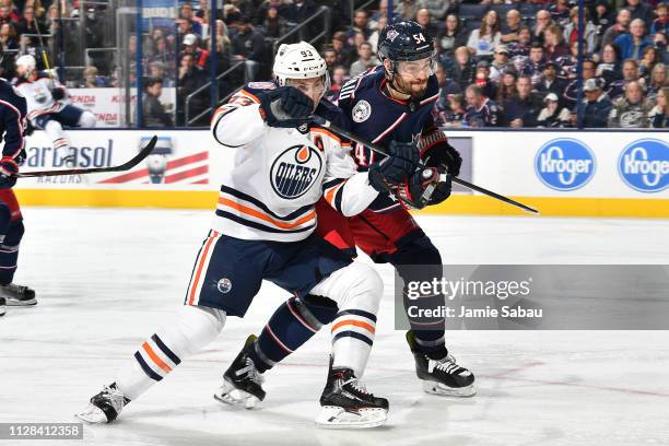 Ryan Nugent-Hopkins of the Edmonton Oilers and Adam McQuaid of the Columbus Blue Jackets battle for position during the second period of a game on...