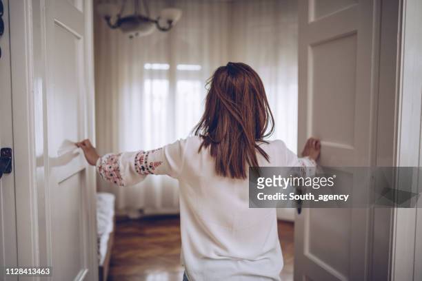 woman entering bedroom - entering stock pictures, royalty-free photos & images