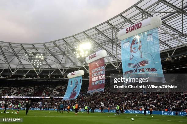 Billy Bonds flags hang in The London Stadium in front of the stand newly named after him during the Premier League match between West Ham United and...