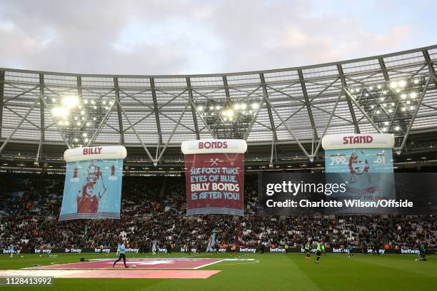 Billy Bonds flags hang in The London Stadium in front of the stand newly named after him during the Premier League match between West Ham United and...