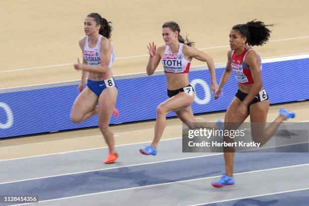 Diana Vaisman of Israel, Alexandra Toth of Austria and Mujinga Kambunji of Switzerland compete in the semi finals of the women's 60m event on March...