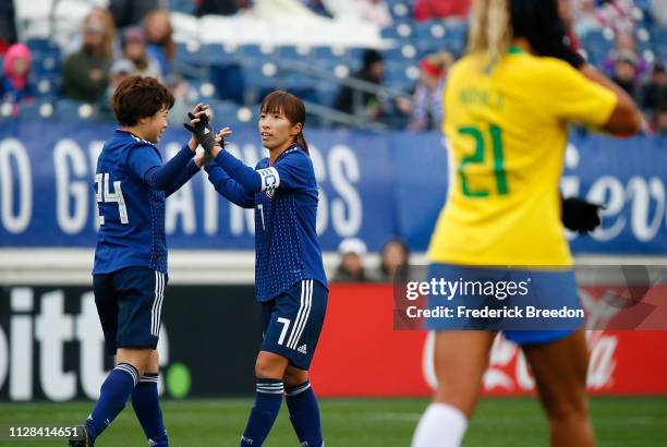 Asato Miyagawa of Japan congratulates teammate Emi Nakajima after a goal against Brazil during the first half of the 2019 SheBelieves Cup match...