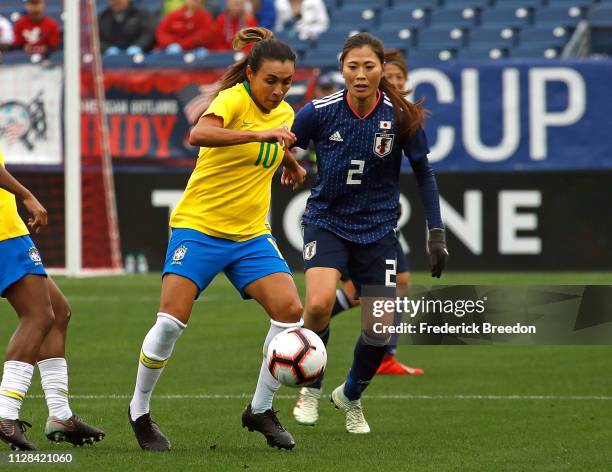 Marta of Brazil plays against Rumi Utsugi of Japan during the first half of the 2019 SheBelieves Cup match between Brazil and Japan at Nissan Stadium...