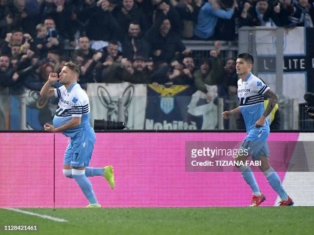 Lazio's forward Ciro Immobile celebrates after scoring during the Italian Serie A football match Lazio vs Roma on March 2 , 2019 at the Olympic...