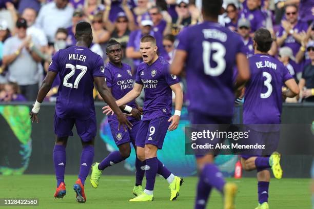 Chris Mueller of Orlando City celebrates his goal with teammates Kamal Miller, Tesho Akindele and Alex De John of Orlando City during a MLS soccer...