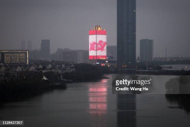 The image of pigs appear on building to celebrate Spring Festival in China on February 09, 2019 in Wuhan, Hubei province, China. The fifth day in the...