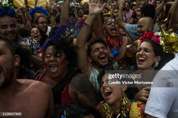 Revellers participate in the Carnival group "Bloco Tarado Ni Você" parade honoring the brazilian singer Caetano Veloso through the streets of...