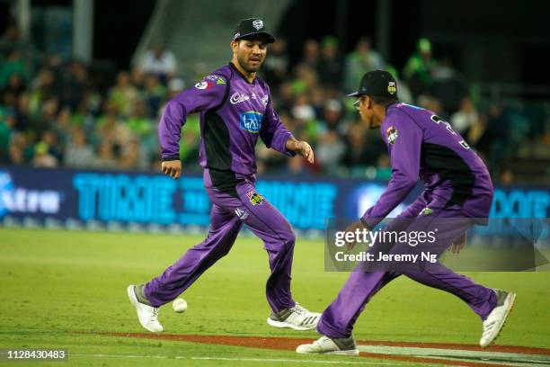 Clive Rose and Qais Ahmad of the Hurricanes field the ball during the Big Bash League match between the Sydney Thunder and the Hobart Hurricanes at...