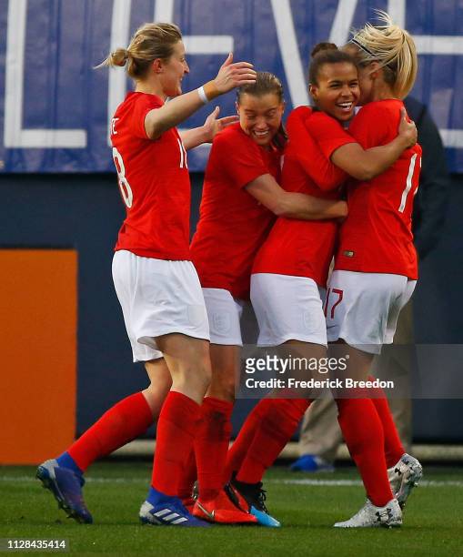 Nikita Parris of England is congratulated by teammate Rachel Daley and Izzy Christiansen after scoring a goal against the United States during the...