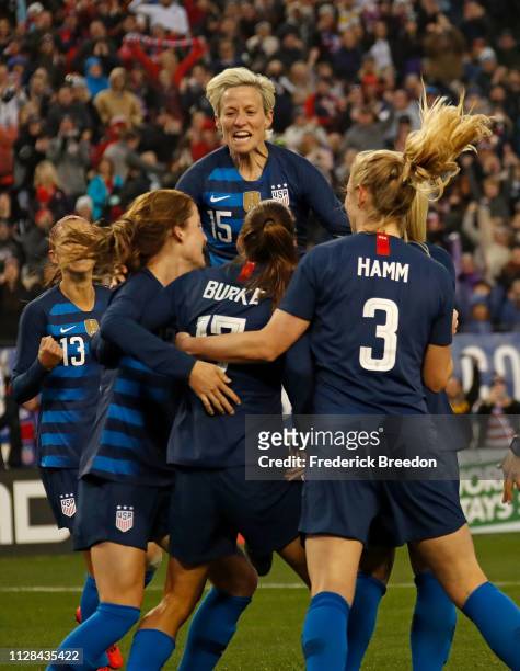 Megan Rapinoe of the United States jumps on top of teammate Tobin Heath in celebration of a goal against England during the second half of the 2019...