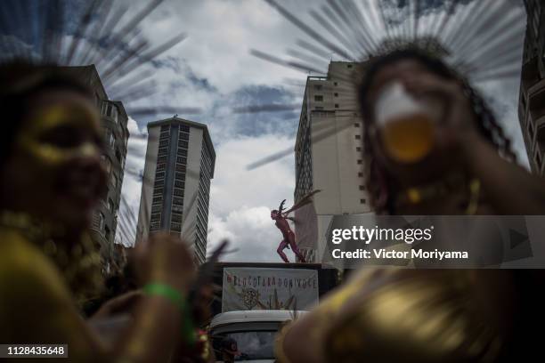 Revellers participate in the Carnival group "Bloco Tarado Ni Você" parade honoring the brazilian singer Caetano Veloso through the streets of...