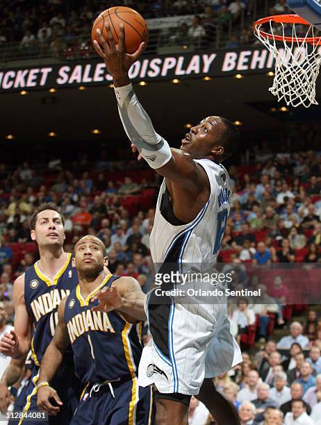 Orlando Magic center Dwight Howard pulls down a rebound in front of Indiana Pacers guard Dahntay Jones and center Jeff Foster during the first half...