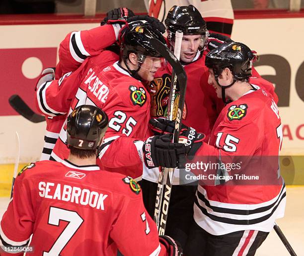Chicago Blackhawks defenseman Brian Campbell, middle, is by teammates after he scored a goal against the New Jersey Devils during the second period...
