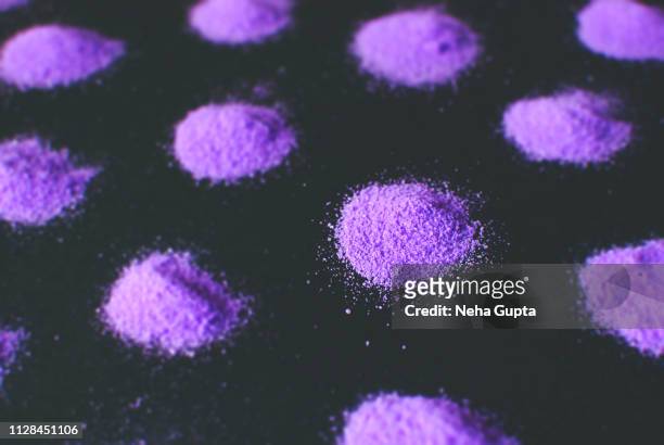 splashes of purple powder paint on a black background - delhi smog stock pictures, royalty-free photos & images