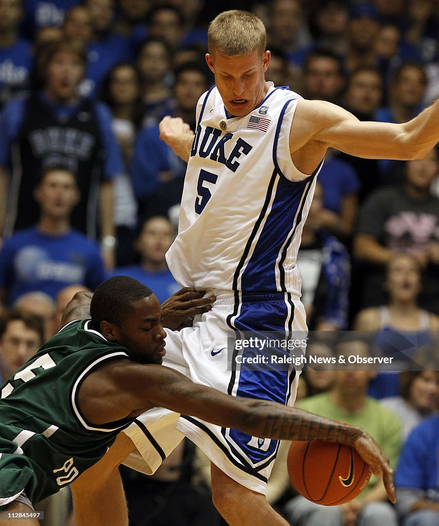 Duke's Mason Plumlee, right, blocks Cal Poly Pomona's Kevin Menner