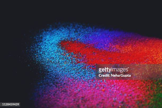 colourful powder paint explosion against a black background - powder burst stock pictures, royalty-free photos & images
