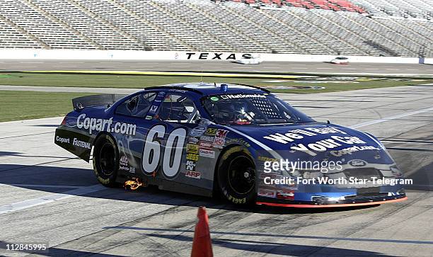 Carl Edwards returns to the garage area during preperation for the O'Reilly Auto Parts Challenge at Texas Motor Speedway in Fort Worth, Texas,...