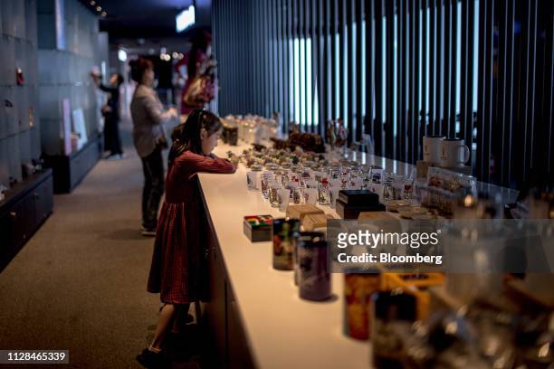 Girl looks at souvenir on sale at the observation deck of Lotte Center in Hanoi, Vietnam, on Sunday Feb. 17, 2019. Vietnam has been building military...