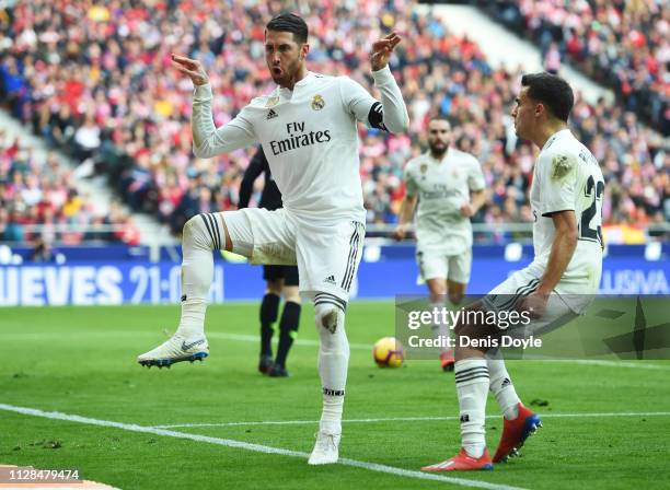 Sergio Ramos of Real Madrid celebrates after scoring his team's second goal from a penalty with Sergio Reguilon during the La Liga match between Club...