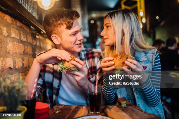 young couple having a meal - valentines couple stock pictures, royalty-free photos & images