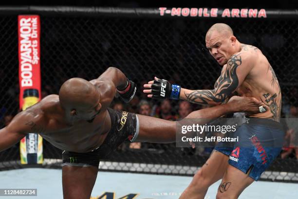 Jon Jones kicks Anthony Smith in their UFC light heavyweight championship bout during the UFC 235 event at T-Mobile Arena on March 2, 2019 in Las...