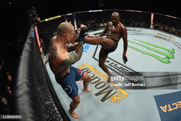 Jon Jones kicks Anthony Smith in their UFC light heavyweight championship bout during the UFC 235 event at T-Mobile Arena on March 2, 2019 in Las...