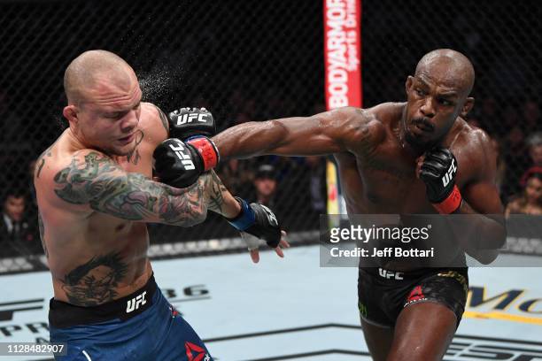 Jon Jones punches Anthony Smith in their UFC light heavyweight championship bout during the UFC 235 event at T-Mobile Arena on March 2, 2019 in Las...
